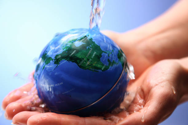 istock Water pouring on planet earth 1077815194