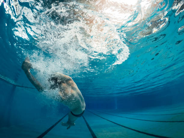 istock Swimming in swimming pool 1077827512