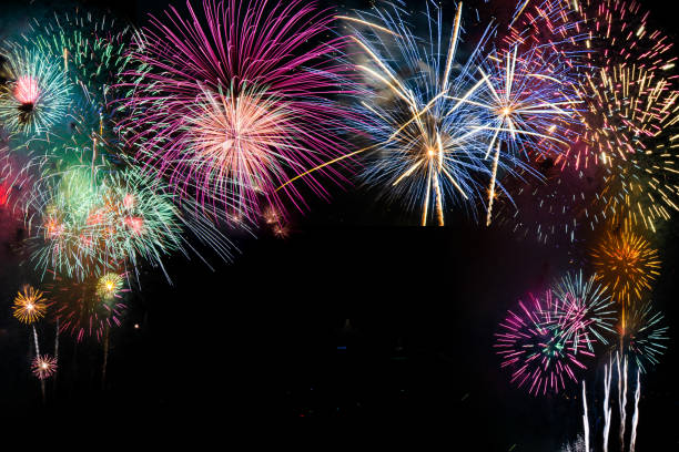 istock colorful fireworks on the black sky background over-water 1077842664