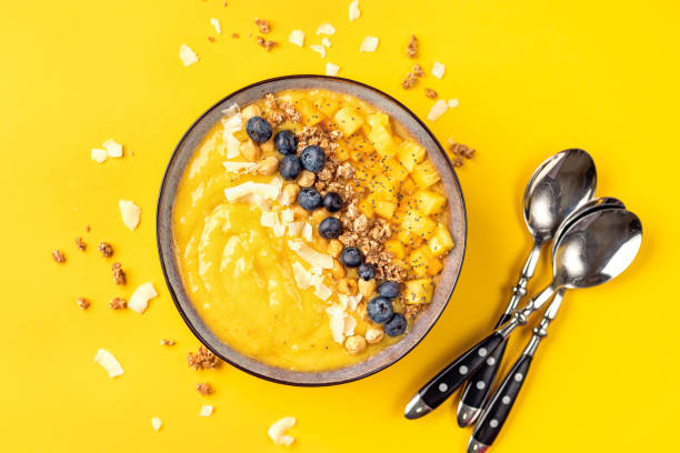 istock Top view of mango smoothie bowl with fruits 1077842798