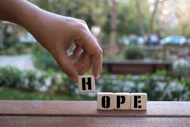 istock HOPE Concept with alphabet blocks on wooden table. 1077842964