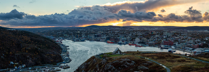 Aerial panoramic view of a modern cityscape on the Atlantic Ocean Coast during a dramatic sunset. Taken in St. John's, Newfoundland and Labrador, Canada.