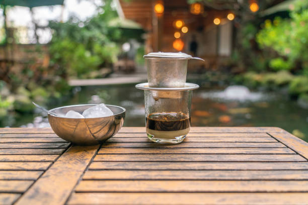 vietnamese style coffee with fish tank background - old fashioned horizontal black coffee cup imagens e fotografias de stock