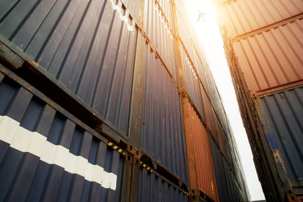 istock Stack of cargo containers at import and export area with cargo airplane at port. 1077847310