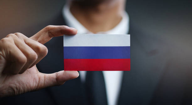 istock Businessman Holding Card Russia Flag 1077849704