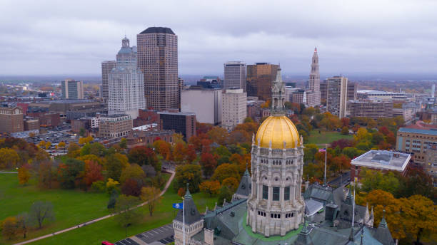 State Capitol Dome Hartford Connecticut Fall Color Autumn Season An aerial view focusing on the Connecticut State House with blazing fall color in the trees around Hartford connecticut state capitol building stock pictures, royalty-free photos & images