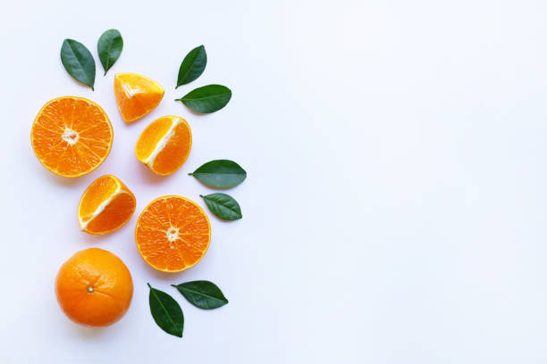 istock Oranges and green leaves on white background. 1077862712