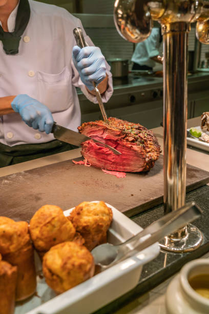 istock Chef slicing and cutting Grilled Beef Steak in the buffet restaurant 1077866800
