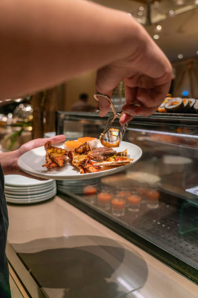 istock Young man choosing food in the hotel buffet 1077866988