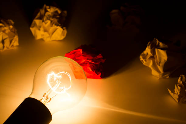 istock Waste paper with glowing light bulb, hope and target 1077876974