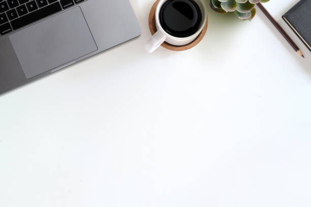 istock Office desk table with computer, office supplies, house plant, coffee cup and copy space. 1077880540