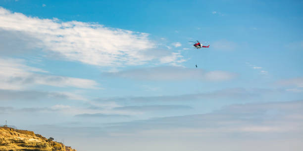 istock Person hanging on chopper above cliff in La Jolla 1077880924