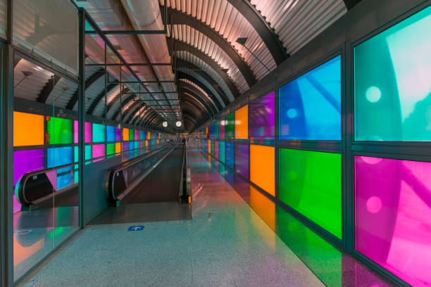 Colorful moving escalator in Barajas Airport, Madrid, Spain