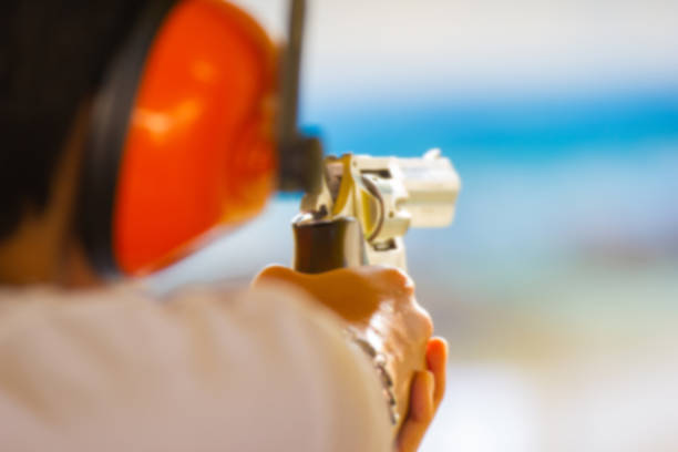istock Hand of Man hold a gun ready to shoot practicing shooting 1077891676