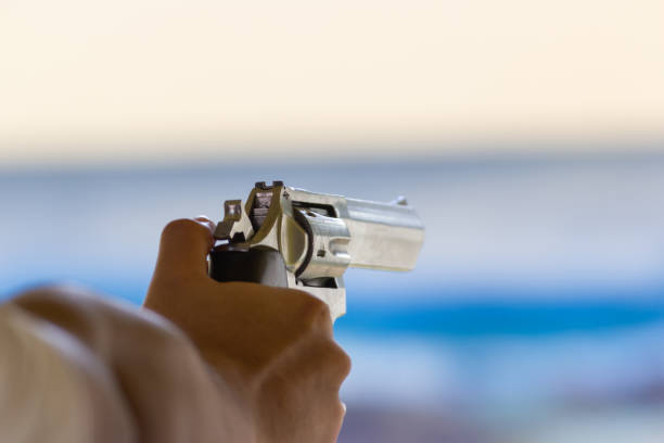 istock Hand of Man hold a gun ready to shoot practicing shooting 1077891718