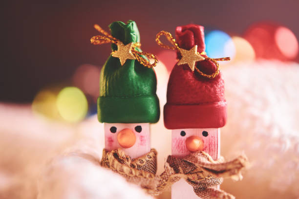 istock Cute handmade snow couple with Christmas lights 1077897918