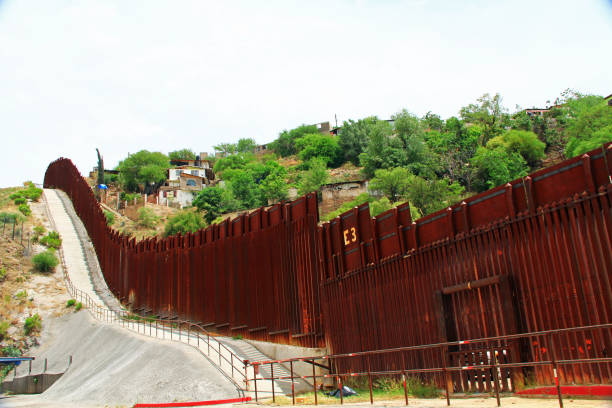 Border Fence Separating the US from Mexico in Nogales, Arizona Border Fence beside a street in downtown Nogales, Arizona separating the United States from Mexico. nogales arizona stock pictures, royalty-free photos & images