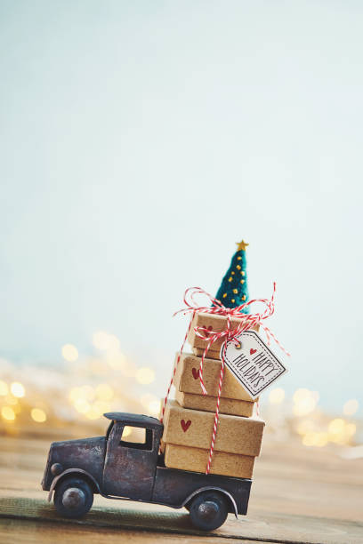 istock Cute little truck with gift stack and Christmas tree 1077901656
