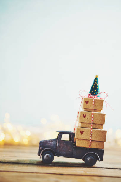 istock Cute little truck with gift stack and Christmas tree 1077901728