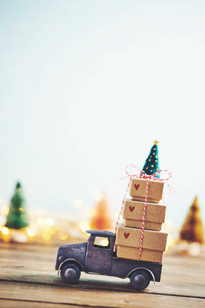 istock Cute little truck with gift stack and Christmas tree 1077901730