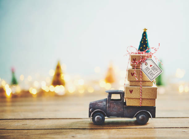 istock Cute little truck with gift stack and Christmas tree 1077901748