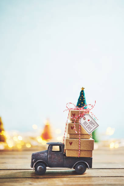 istock Cute little truck with gift stack and Christmas tree 1077901754