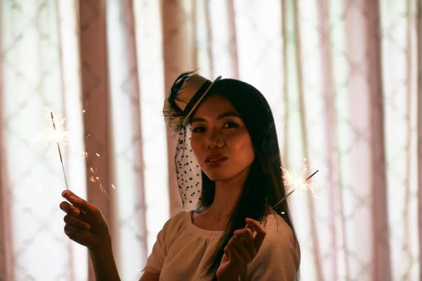 istock Pretty woman with sparklers 1077906340