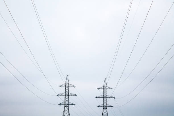 istock Two symmetrical metal electrical towers with wires 1077906434