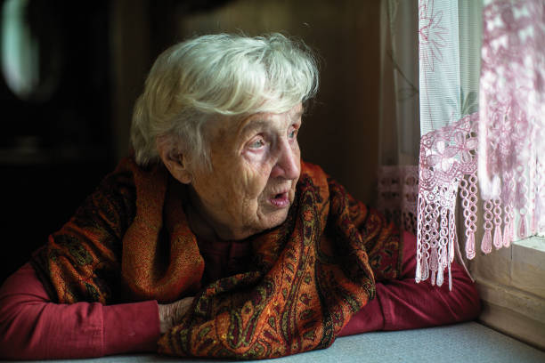 istock Elderly woman sitting at the table. 1077906478