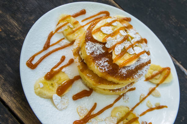 istock Pancakes and bananas topped with caramel and icing. 1077908832