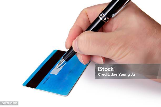 Businessmans Hand Signing The Back Of His Credit Card Stock Photo - Download Image Now