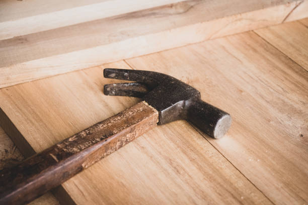 istock hammer on wooden table light brown 1077911456
