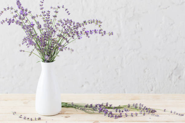 istock lavender in white vase on wooden table 1077911526