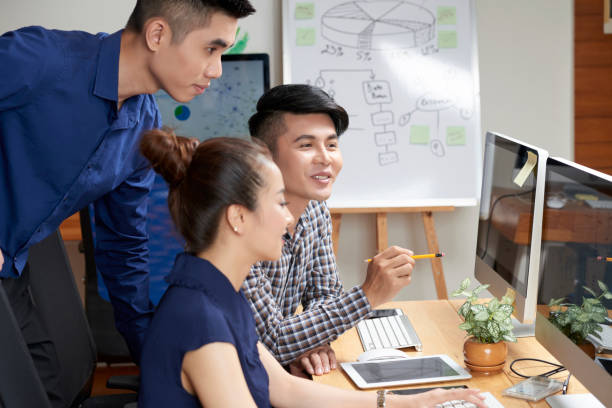 istock Asian business team discussing project 1077916114