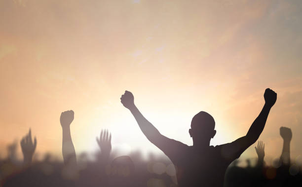 International human rights day concept: Silhouette human hands raising at night background stock photo