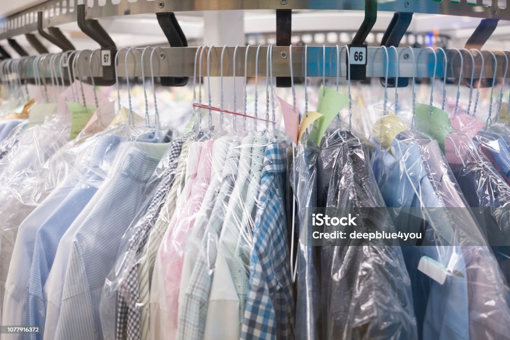 Dry-cleaning Dry cleaning: Clothes hang on the stand Dry Cleaner Stock Photo