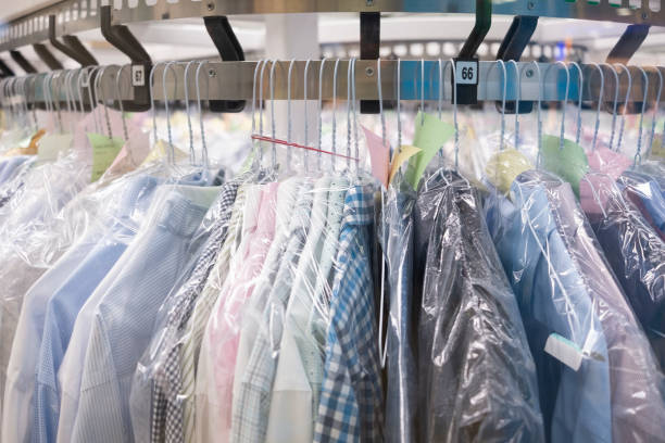 Dry-cleaning Dry cleaning: Clothes hang on the stand dry cleaner stock pictures, royalty-free photos & images