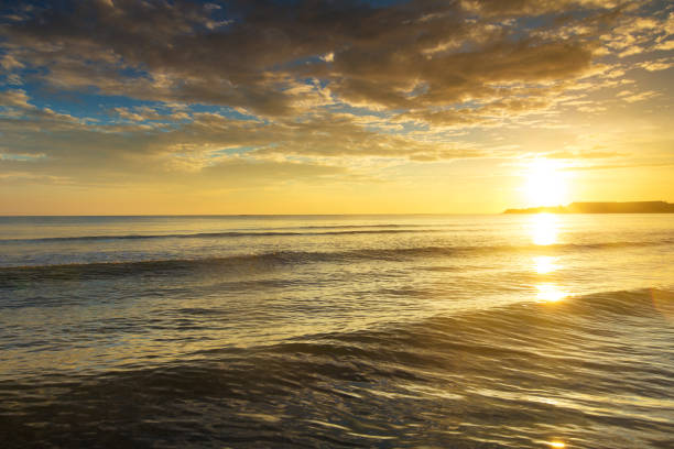 istock sunset over ocean on tropical island 1077916430