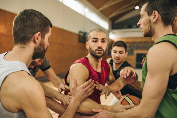 istock Focused basketball player among defensive players on a match. 1077921454