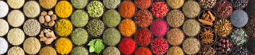 bright Indian spices and herbs in cups, top view. background for packing with condiments.