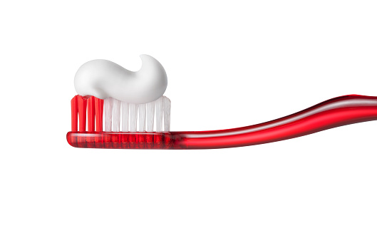 Toothbrush with toothpasteon on white background.