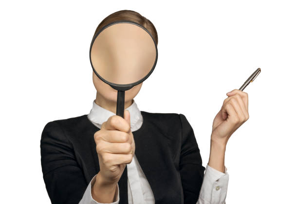istock girl's face is covered with a magnifying glass 1077937704