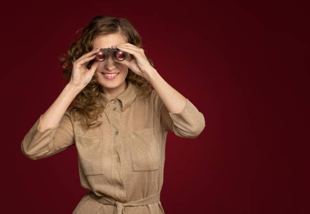 istock girl as a spy with binoculars 1077937956