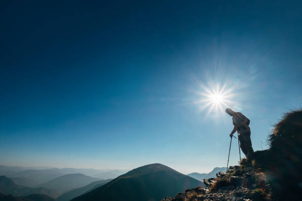 istock Backpacker hiker on the mountain hill in contrast sunlight going down in the high mountain. Healthy lifestyle concept. 1077942722