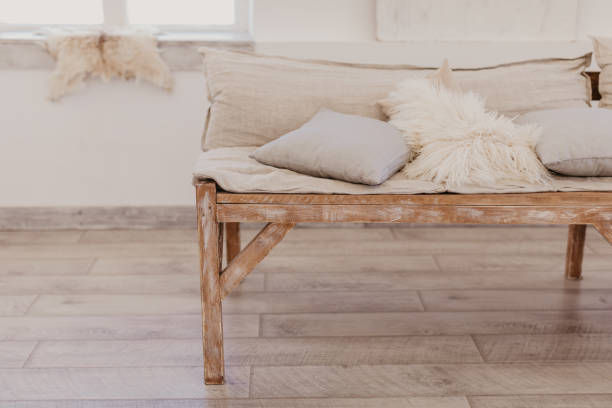 handmade wooden sofa in bright room, soft pillows\