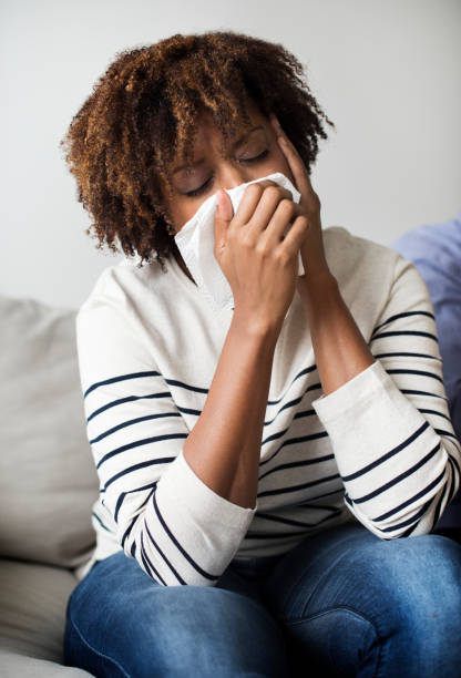 istock Woman sick and sneezing 1077945038