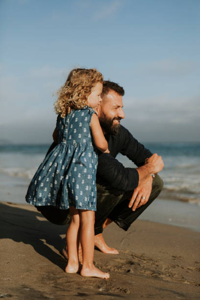 istock Father and daughter at a beach 1077945528
