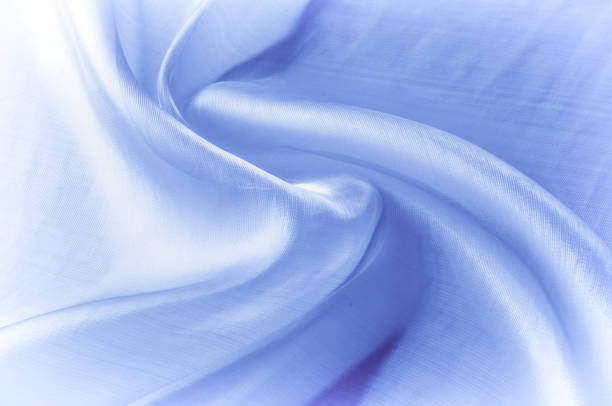 istock Background texture, pattern. Blue silk fabric. Smooth elegant blue silk or satin can use as background. Luxurious Christmas background or New Year background design 1077946914