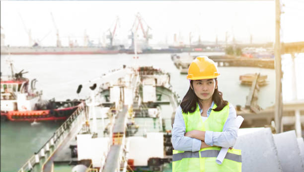istock Engineering wearing yellow helmet and working at construction site about transportation of international logistics background 1077957302