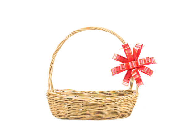 Empty wicker basket with red and gold ribbon isolated on white background